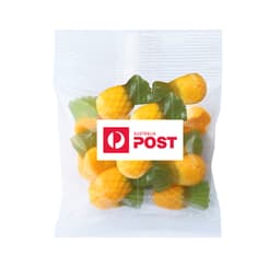 A clear bag containing pineapple-shaped gummy sweets in yellow and green, featuring a logo.