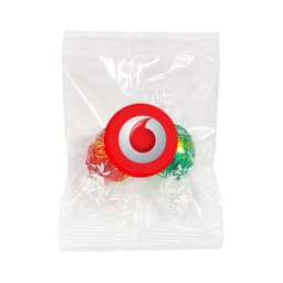 Two Lindt chocolate balls in red and green packaging, sealed in a clear plastic bag with a logo.