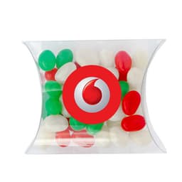 A transparent pillow pack contains red, green, and white mini jelly beans, featuring a logo on the front.