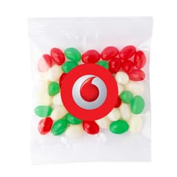 A clear bag contains red, green, and white jelly beans, with a logo printed on the front.