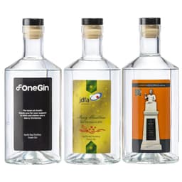 Three clear glass bottles of Apollo Bay Distillery Ocean Gin, featuring various labels and a cork stopper.