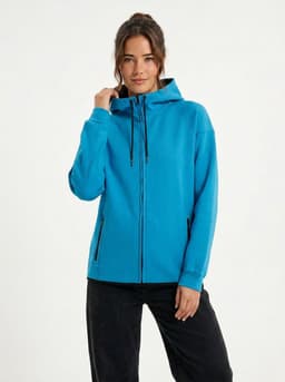 A grey soft cotton bonded polar fleece hoodie with a zippered front and pockets, worn with black leggings.