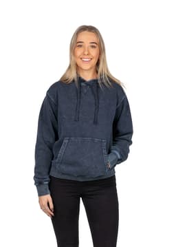 A woman wearing a navy stone wash fleece hoodie, featuring a kangaroo pocket and drawstrings.