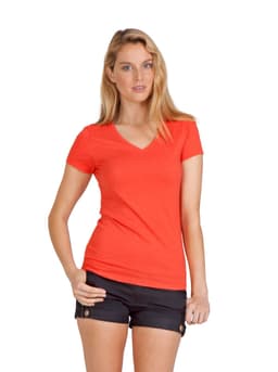 A woman wearing an orange marl V-neck T-shirt paired with black shorts and sandals, posing against a plain background.