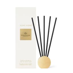 A decorative diffuser with black reeds, presented in a white box. The product features a gold logo and assorted scents.