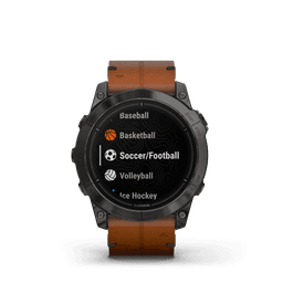 A watch with a black face displaying sports options, featuring a carbon grey titanium body and a chestnut leather band.