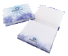 A notepad with a hard cover featuring a blue and white design, open to display blank pages inside.