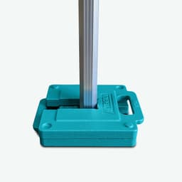 A turquoise gazebo leg weight with a slot for a supporting pole, designed for stability in outdoor settings.