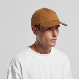 A man wearing a brown Access Canvas Cap, paired with a plain white t-shirt, against a neutral background.