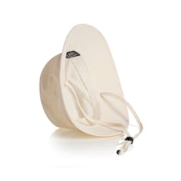 A cream nylon wide brim bucket hat featuring an adjustable chin strap and an inner lining. It has a logo on the inside.