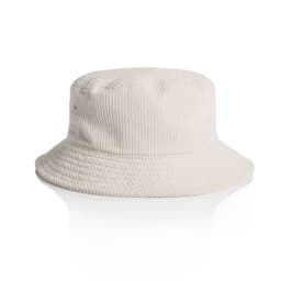 A cord bucket hat in a light beige colour with a wide brim and textured fabric. It features a logo.