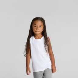 A white kids' tank top is worn by a child with long hair, paired with grey pants. The top features a logo.