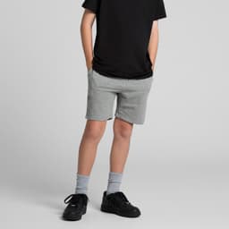 Youth stadium shorts in grey, featuring a comfortable fit and side pockets, worn with a black shirt and sneakers.