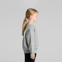 A grey sweater for kids, featuring a crew neck and long sleeves, displayed on a child from the side.