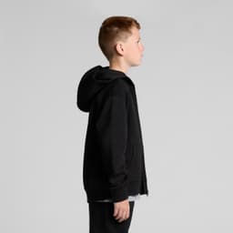 A black zip-up hoodie for youth features a hood and a front zip. The model is shown from the side.