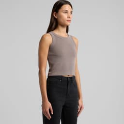 A cropped rib tank top in a muted grey colour, paired with black jeans. The top features a subtle logo.