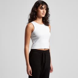 A white organic rib crop tank top displayed on a model, paired with black trousers. Features a logo.