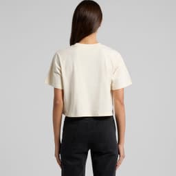 A cream crop t-shirt viewed from the back, featuring short sleeves and a simple design. It has a logo on the back.