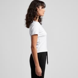 A white organic rib baby tee with a fitted design, displayed from the side. The model is wearing black bottoms.