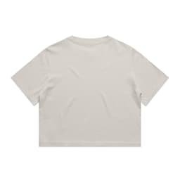 A heavy faded crop tee in a neutral beige colour, featuring short sleeves and a relaxed fit. The garment has a logo.