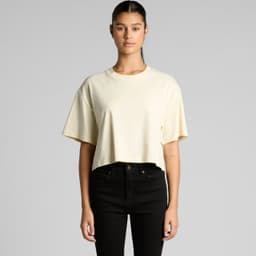 A cropped tee in a soft yellow hue, featuring short sleeves and a relaxed fit, with a logo on the front.