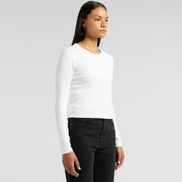 A long-sleeve white t-shirt is displayed on a model, paired with black jeans. The shirt has a simple design and a logo.