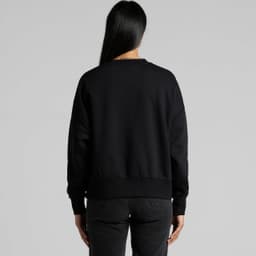 A black crew jumper featuring a relaxed fit and ribbed cuffs, shown from the back. The model is wearing black jeans.