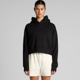 A black cropped hoodie with a hood and long sleeves, styled casually with light-coloured shorts.