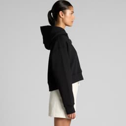 A black cropped hoodie with a large hood, displayed on a model from the side.