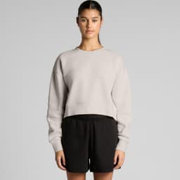 A light grey cropped jumper with a relaxed fit, paired with black shorts, featuring a branding logo.