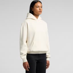 A cream hoodie with a front pocket and a hood, displayed on a model against a plain background.