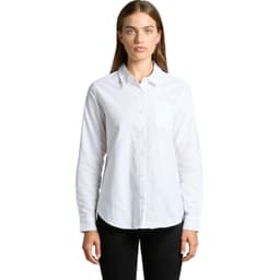 A white button-up shirt featuring long sleeves and a chest pocket. The model poses straight-on against a plain background.