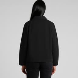 A black canvas chore jacket displayed from the back, featuring a collared neckline and a subtle logo.