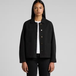 A black canvas chore jacket with a collared neckline and front pockets, modelled by a woman.