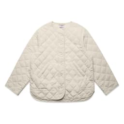 A cream-coloured quilted jacket with a rounded hem and snap buttons, featuring a logo on the label.