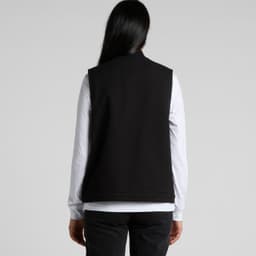 A black heavy canvas vest with a simple design, featuring a back view and no visible logos.