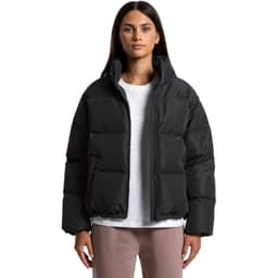 A puffer jacket in black, featuring a zip front and a relaxed fit, worn by a model against a plain background.