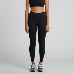 Active seamless leggings in black, styled with a matching crop top and trainers. The product features a logo.