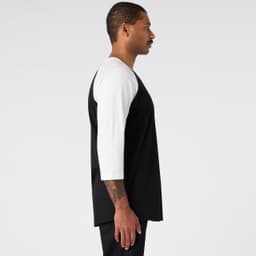 A black and white raglan t-shirt featuring three-quarter length sleeves and a logo on the chest.