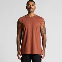 A man wearing a sleeveless, burnt orange tank top with a plain design. The top has a logo on it.
