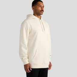 A cream-coloured hoodie featuring a front pocket and a hood. The model stands in a neutral pose.