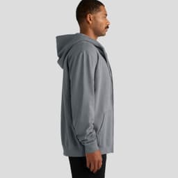 A grey zip-up hooded jumper with a front pocket and a logo on the side, displayed on a model from the side.