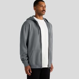 A grey zip hoodie with a front pocket and drawstring hood, worn by a man against a grey background.