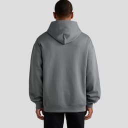 A grey hooded sweatshirt with a relaxed fit, featuring a spacious back and a hood. It has a logo.