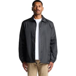 A black coach jacket featuring a button-up front and a relaxed fit, worn by a model.