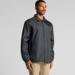 A black coach jacket featuring a point collar and elasticised cuffs, with a logo present.