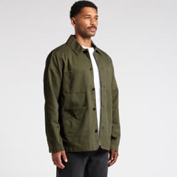 An olive green Chore Jacket featuring multiple pockets, button front, and a classic collar design.