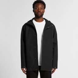 A black rain jacket with a hood, featuring a front zip and snap closure, modelled by a person.