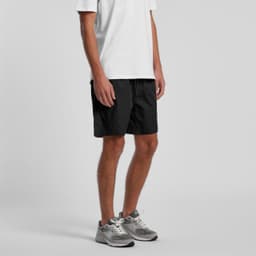 Black sports shorts featuring side pockets and a branded logo. Suitable for casual wear or sporting activities.
