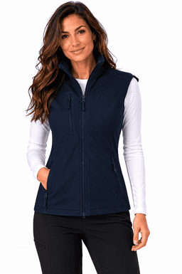 A woman models a navy blue work vest with multiple zippered pockets and a zipped front. The vest has a logo.